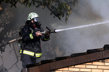 Fireman on the roof in a smoky environment