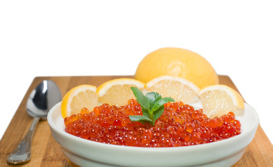 Red caviar on plate with lemon