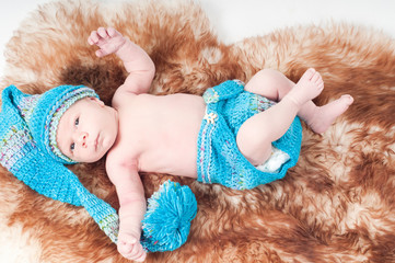 Newborn baby in long knitted hat