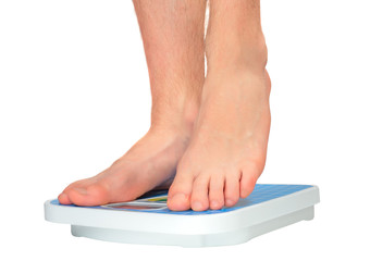 Man's legs ,which weighed on floor scale. Isolated