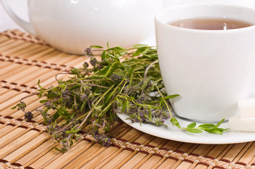 cup of herbal tea and teapot