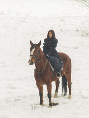 Beautiful woman and horse in winter
