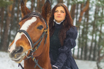 Beautiful woman and horse in winter