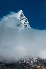 Fototapeta na wymiar Cholatse mountain peak and clouds