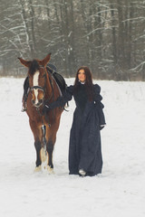 Beautiful woman and horse in winter