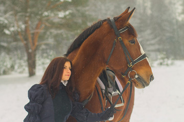 Beautiful woman and horse in winter