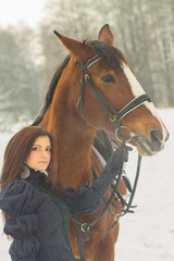 Obraz premium Beautiful woman and horse in winter