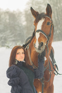Beautiful woman and horse in winter