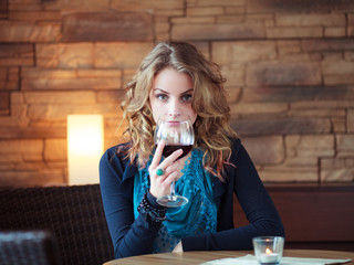 Beautiful Girl In Restaurant holding glass with red wine - 47779886