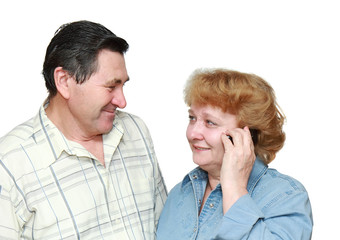 Old couple, woman speaks by a mobile phone.