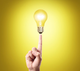 bulb light on women fingertip