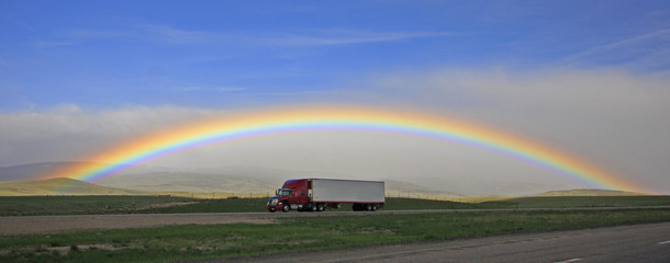 Rainbow over highway with Semi-Truck