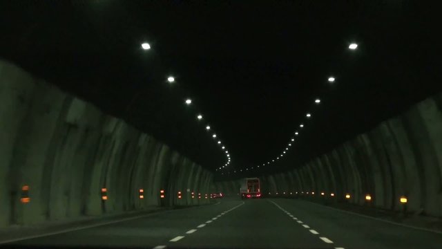 Car drives though tunnel