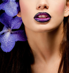 Fototapeta premium Fashionable beautiful woman with orchid in her hair