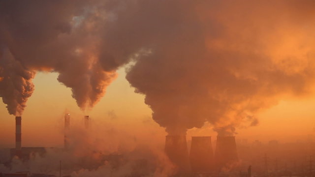 Polluting factory at dawn