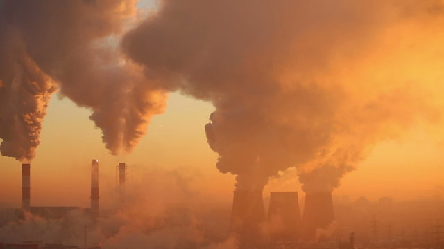 Polluting factory at dawn, time-lapse
