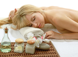 Obraz na płótnie Canvas A beautiful woman enjoying spa treatment is lying