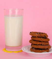 Glass of fresh new milk on pink background