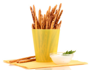 Tasty crispy sticks in yellow plastic cup isolated on white