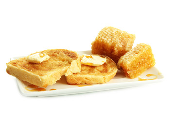White bread toast with honey on plate, isolated on white