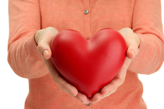 Red heart in woman hands, close up