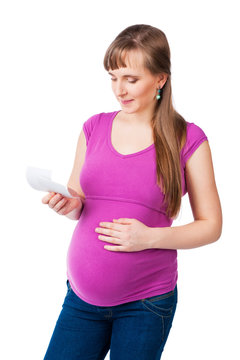 Pregnant woman holding the ultrasound exam result