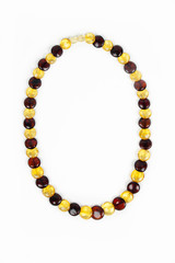 Amber beads of  transparent amber close up isolated on a white b