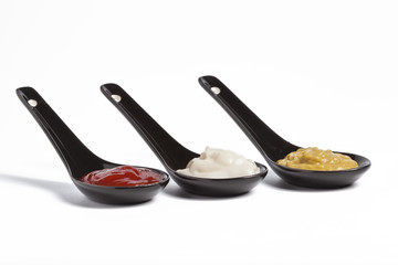 Spoons with ketchup, mayonnaise and mustard