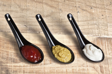 Spoons with ketchup, mayonnaise and mustard