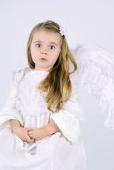 A beautiful little girl angel with a book