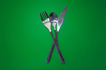 Table serving-dishware on green backdrop.