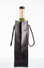 A bottle of wine in a black bag