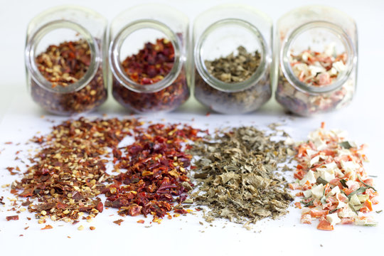 Dried spices in jar on white background closeup