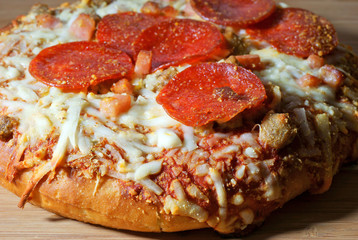 Close view of a cooked thick crust pizza
