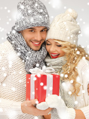 romantic couple in a sweaters with gift box