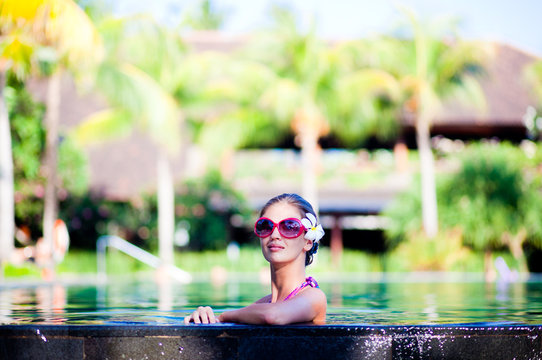 portrait of young attraactive smiling woman in luxury pool