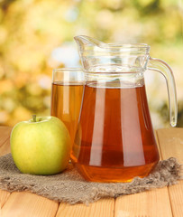 Full glass and jug of apple juice and apple