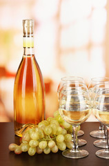 White wine in glass and bottle on room background