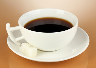 A cup of strong coffee on beige background