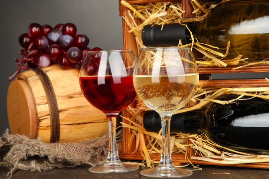 Wooden case with wine bottles, barrel, wineglass and grape