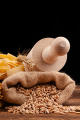 corn and pasta assortment on black background