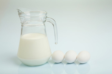 Milk in a glass jar and eggs