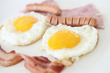 Breakfast with bacon , fried egg and orange juice