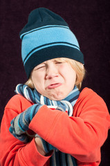 Crying boy in winter clothing