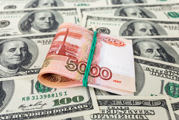 Folded five thousandths rouble bills on dollars background