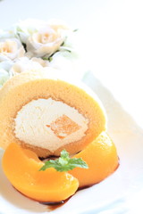 home bakery Peach swiss roll with flower on background