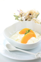 healthy dessert, peach and yogurt with flower on background