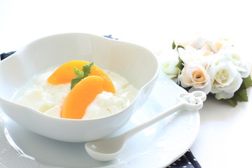 Peach and Yogurt with flower on background