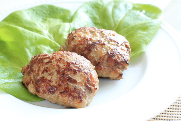 homemade hamburger steak with lettuce on white dish