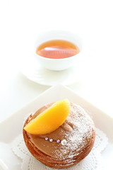 home bakery, chocolate pastry cake with peach on top
